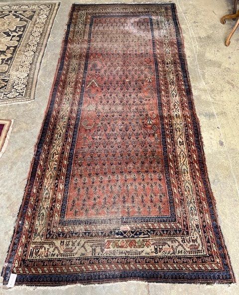 A Shirvan red ground carpet, 330 x 134cm